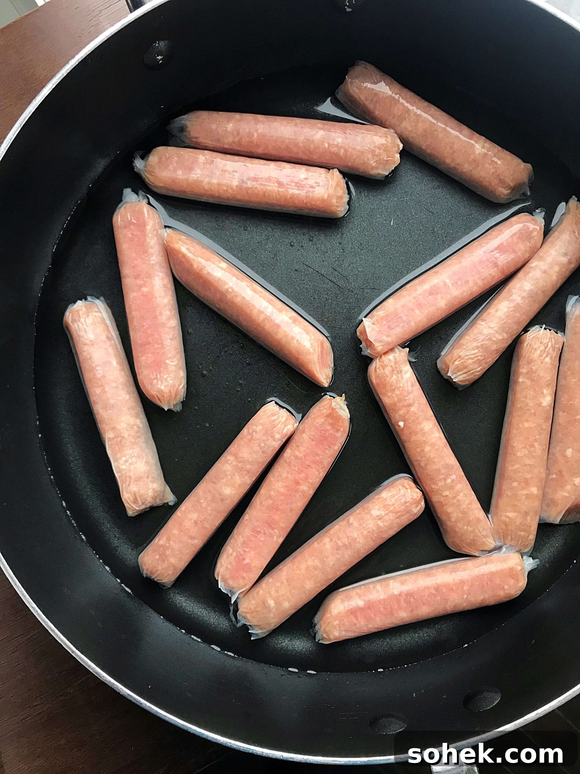 Sausages in a large skillet with water