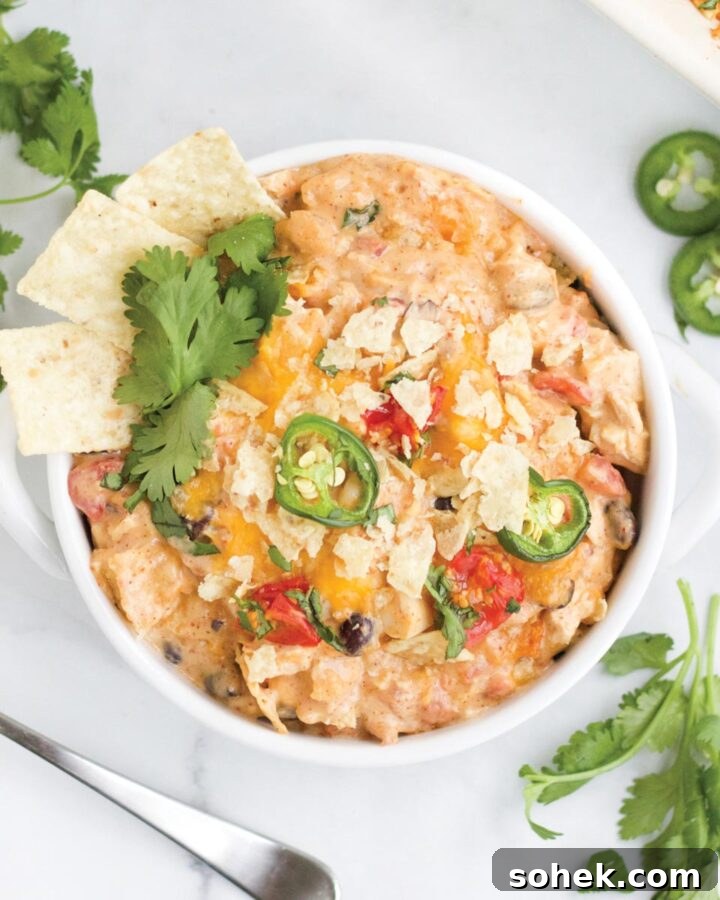Chicken taco casserole served up in a bowl on the table.