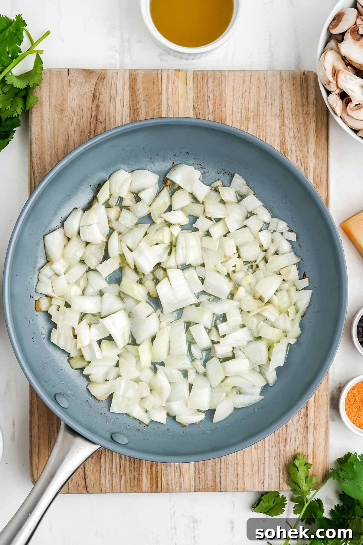 Onions cooking in a skillet.