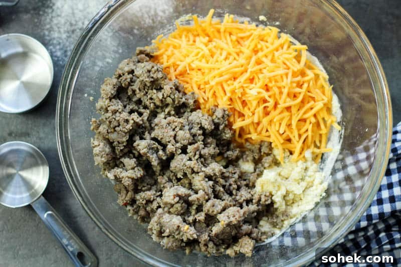 Ground sausage, cheese, and almond flour in a glass bowl