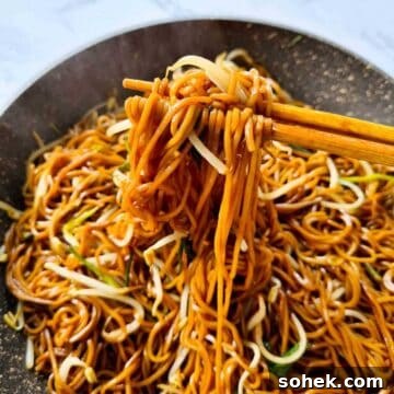 Hot noodles being picked up by a pair of chopsticks