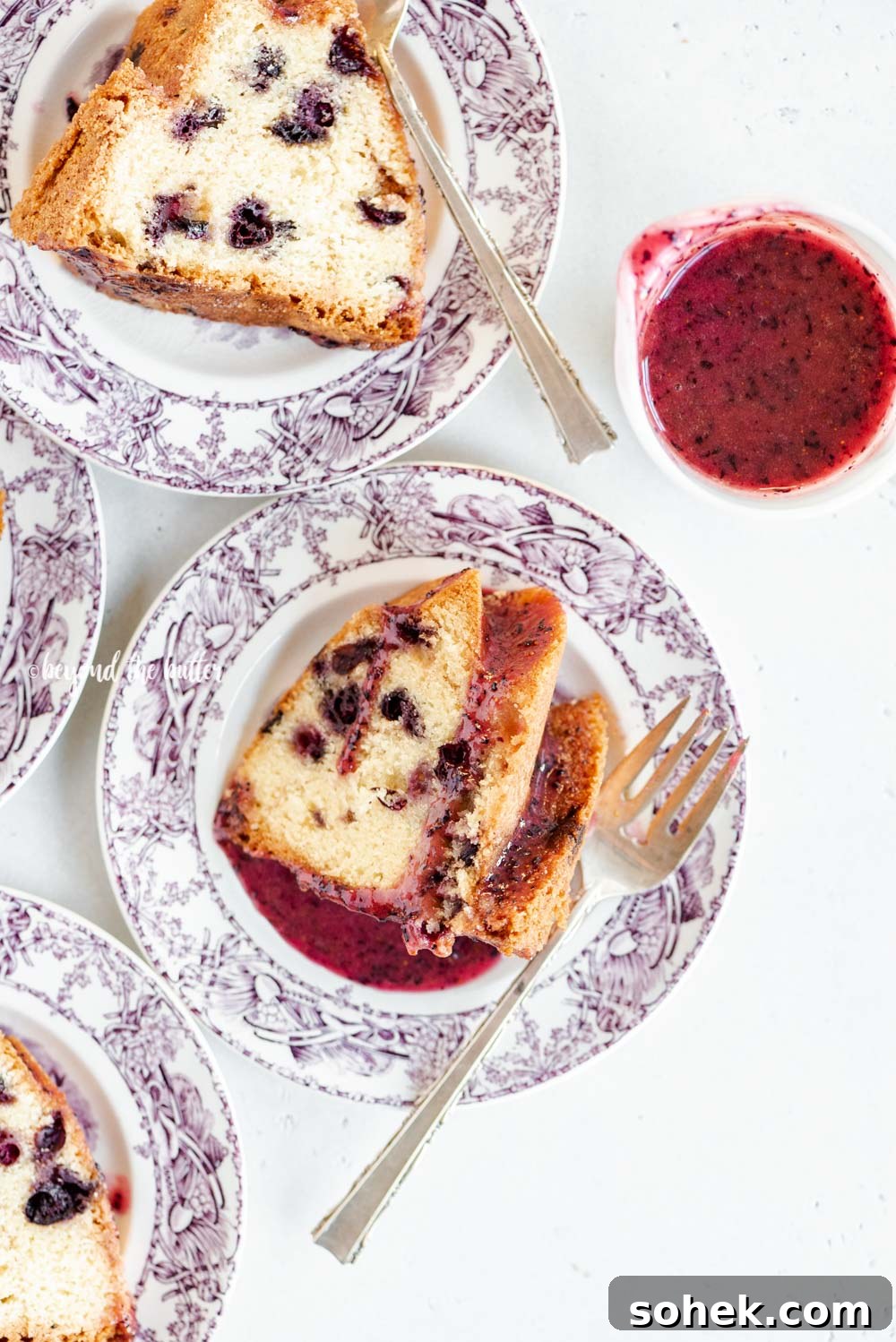 Slices of blueberry bundt cake with blueberry glaze drizzled over the top | All Images © Beyond the Butter, LLC