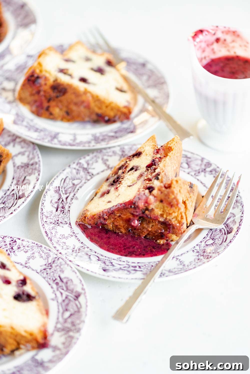 Slices of blueberry bundt cake with blueberry glaze drizzled over the top | All Images © Beyond the Butter, LLC