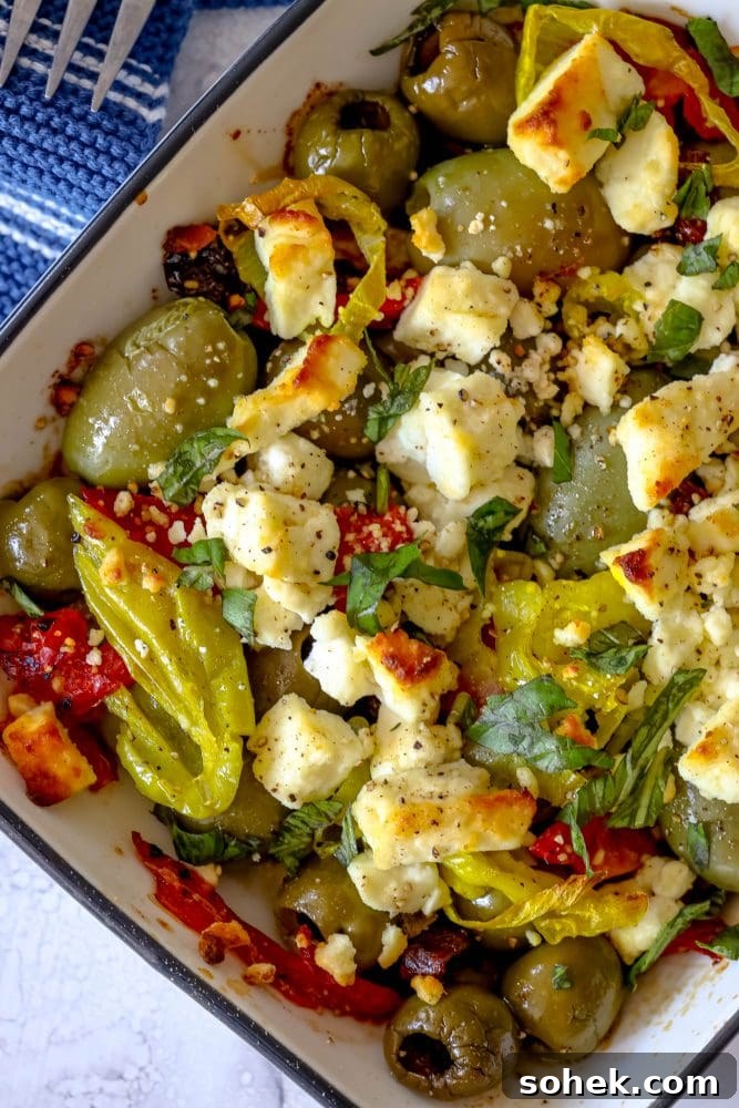 Mediterranean Baked Olives with Feta and Herbs 11 picture of baked olives and feta in a white glass dish