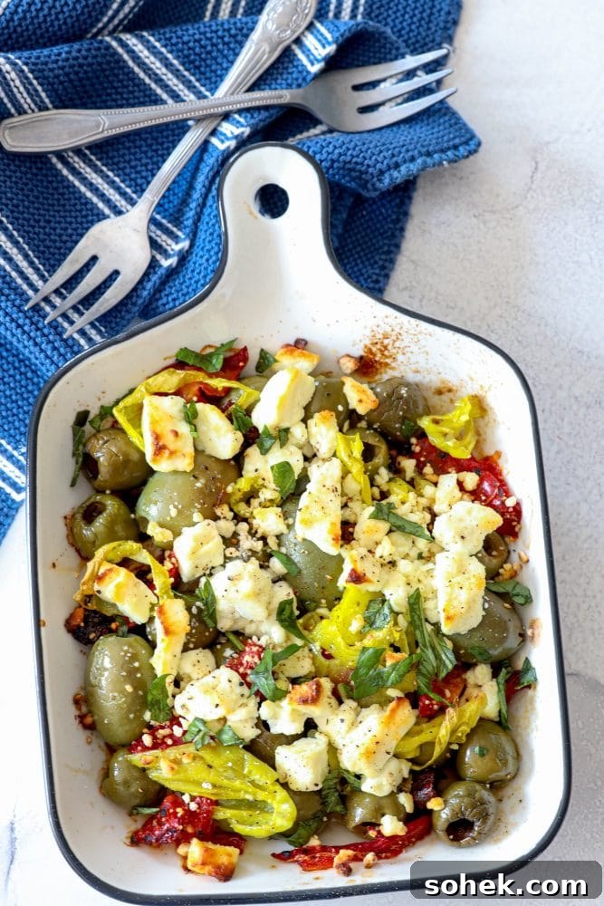 Mediterranean Baked Olives with Feta and Herbs 16 picture of baked olives and feta in a white glass dish