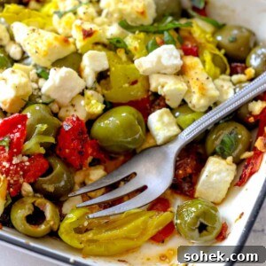 Mediterranean Baked Olives with Feta and Herbs 18 picture of baked olives and feta in a white glass dish