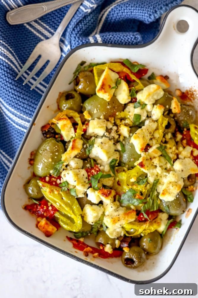 Mediterranean Baked Olives with Feta and Herbs 4 picture of baked olives and feta in a white glass dish