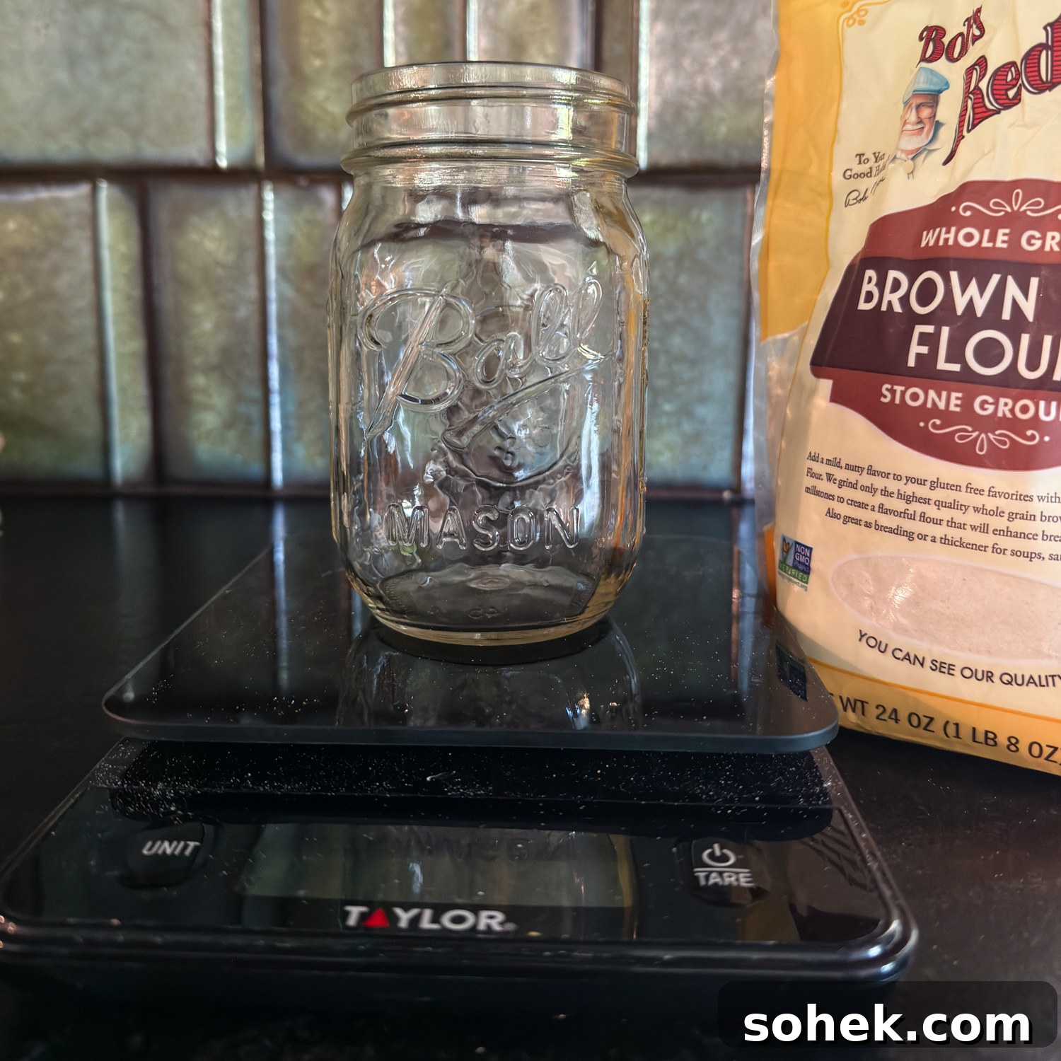 Gluten-Free Sourdough Starter: Reliable Step-by-Step Recipe 4 an empty glass jar on a scale with brown rice flour in the background.