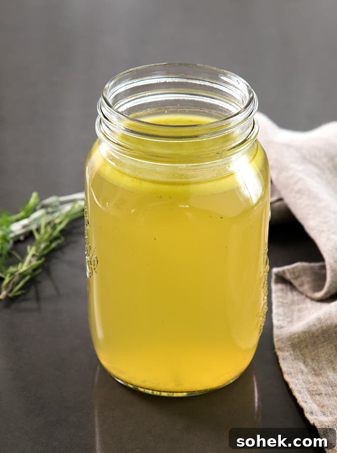 Rich Gluten-Free Chicken Stock Recipe for Flavorful Broths 2 A glass jar of chicken stock on a table