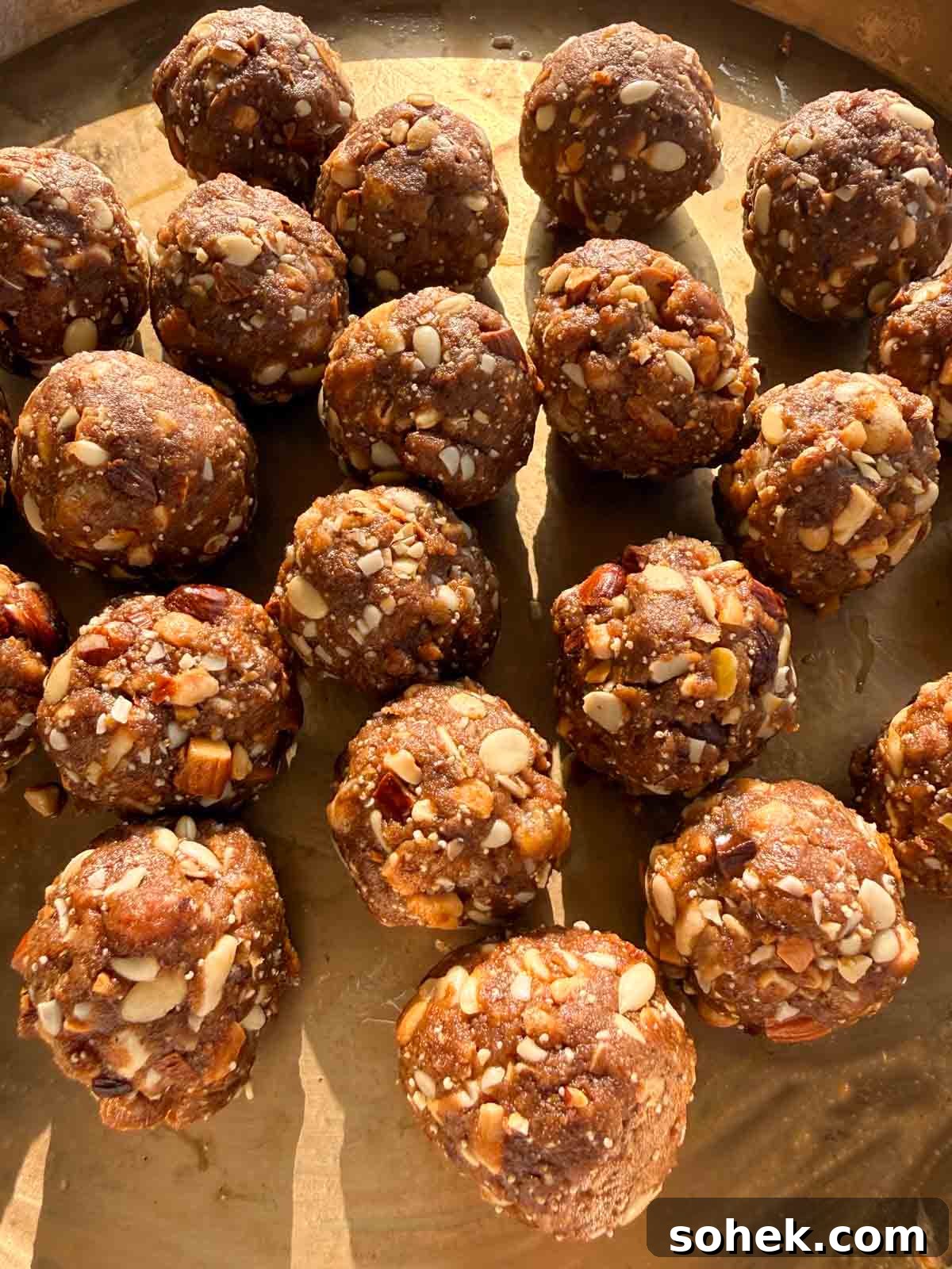 Gond Laddu (Pinni) Recipe: How to Make Traditional Dink Laddu 3 close up image of gond ke laddu to showcase their texture