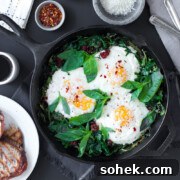 Baked Eggs with Ricotta, Greens & Sun Dried Tomatoes