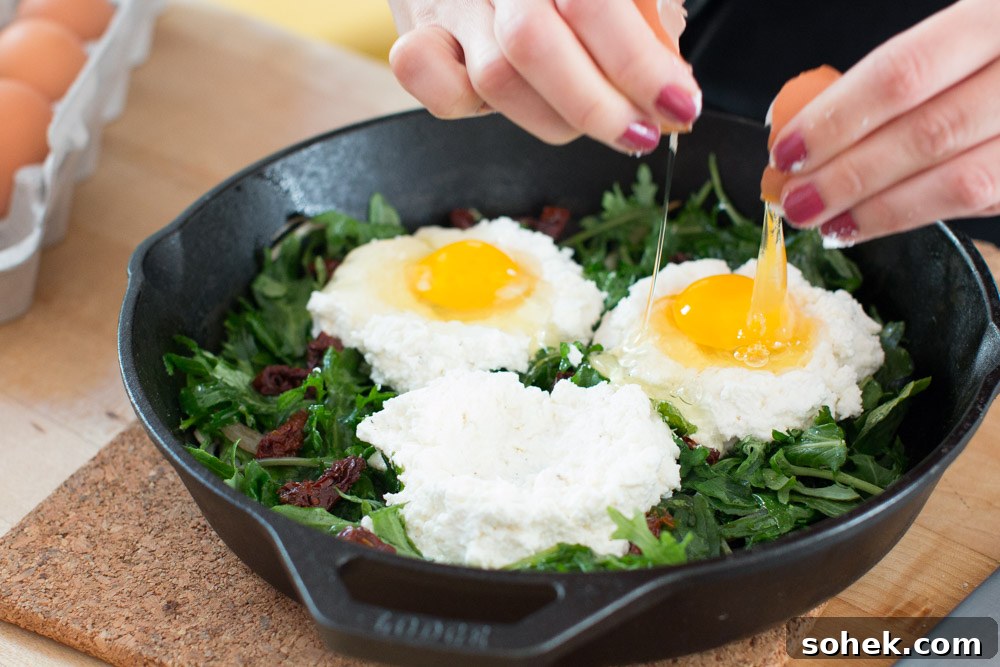 Baked Eggs with Ricotta, Greens & Sun Dried Tomatoes egg drop ricotta and eggs