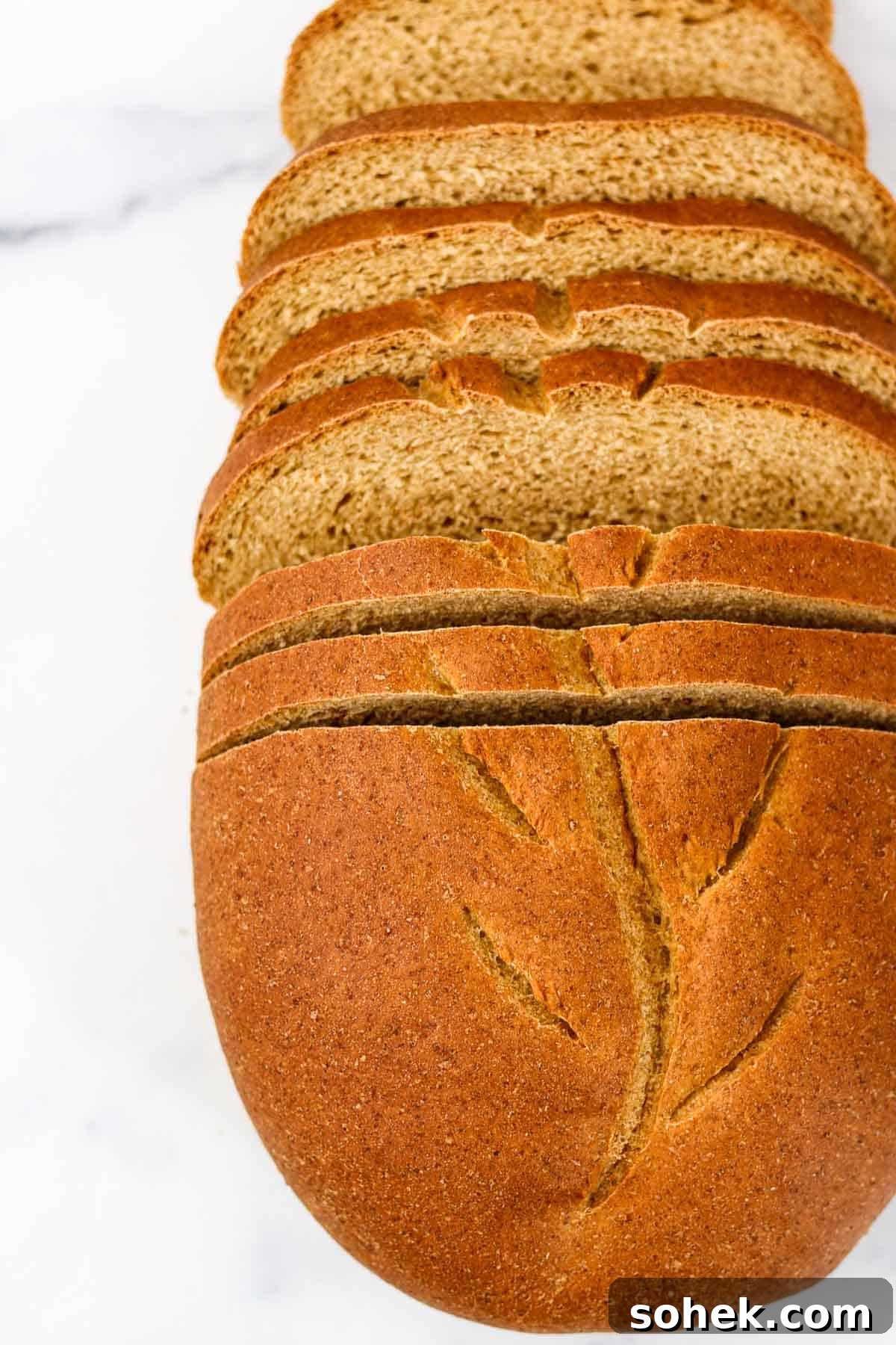 Swedish Limpa Bread sliced on a marble surface.