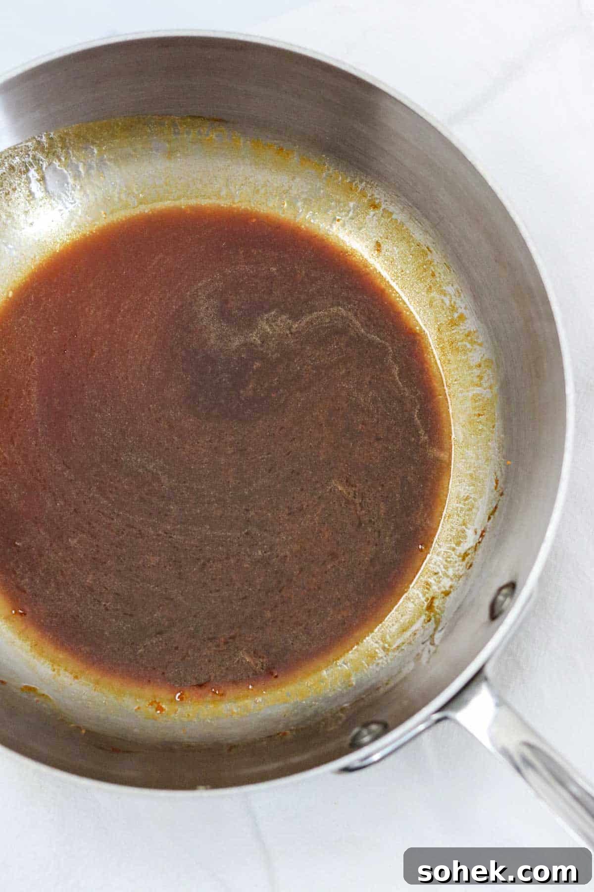 Molasses and butter mixture in a metal pan.