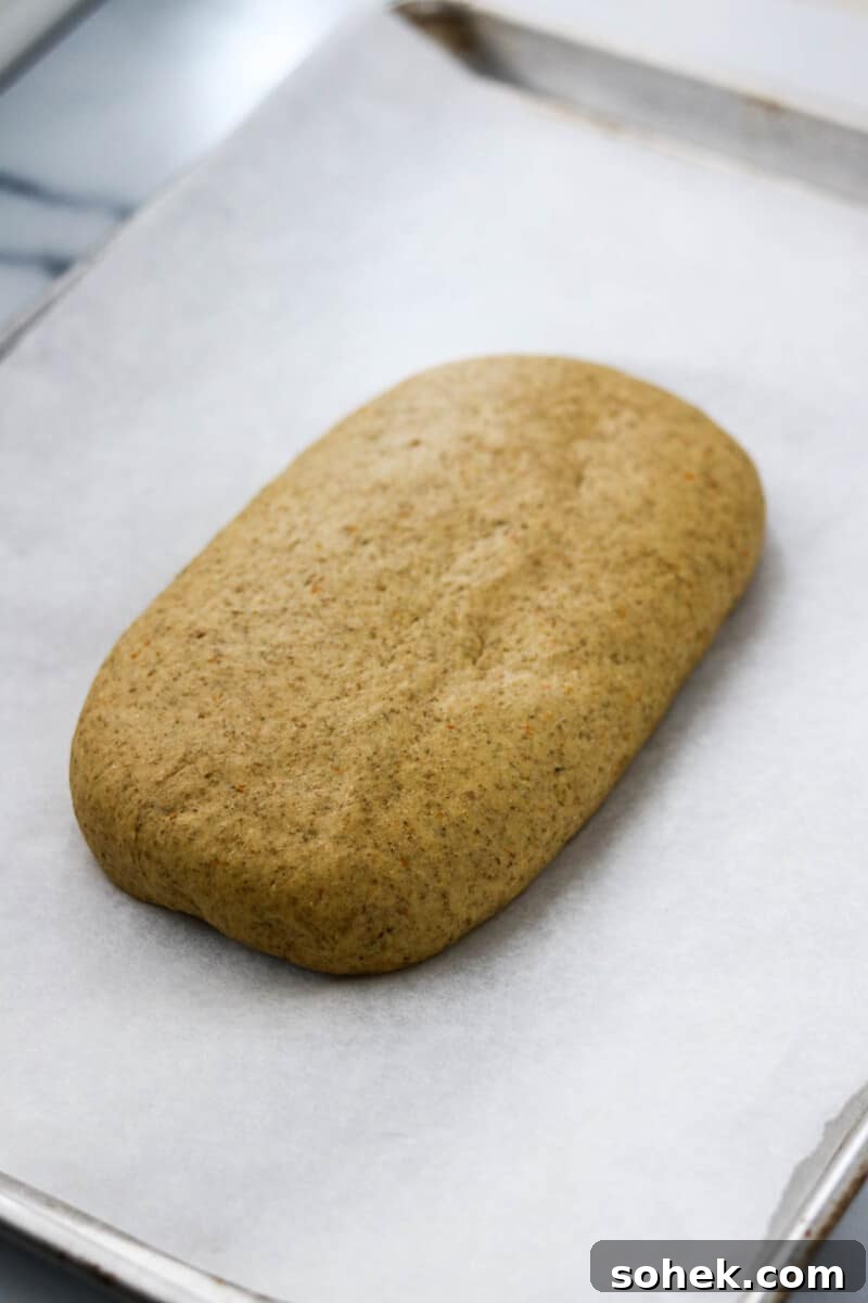 Rye bread dough on a baking sheet.