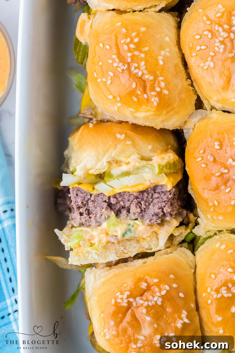 Big Mac Sliders are the miniature version of your favorite fast food burger! Juicy little hamburgers with pickles, onions, lettuce, the "secret sauce", and then surrounded by buttery buns.