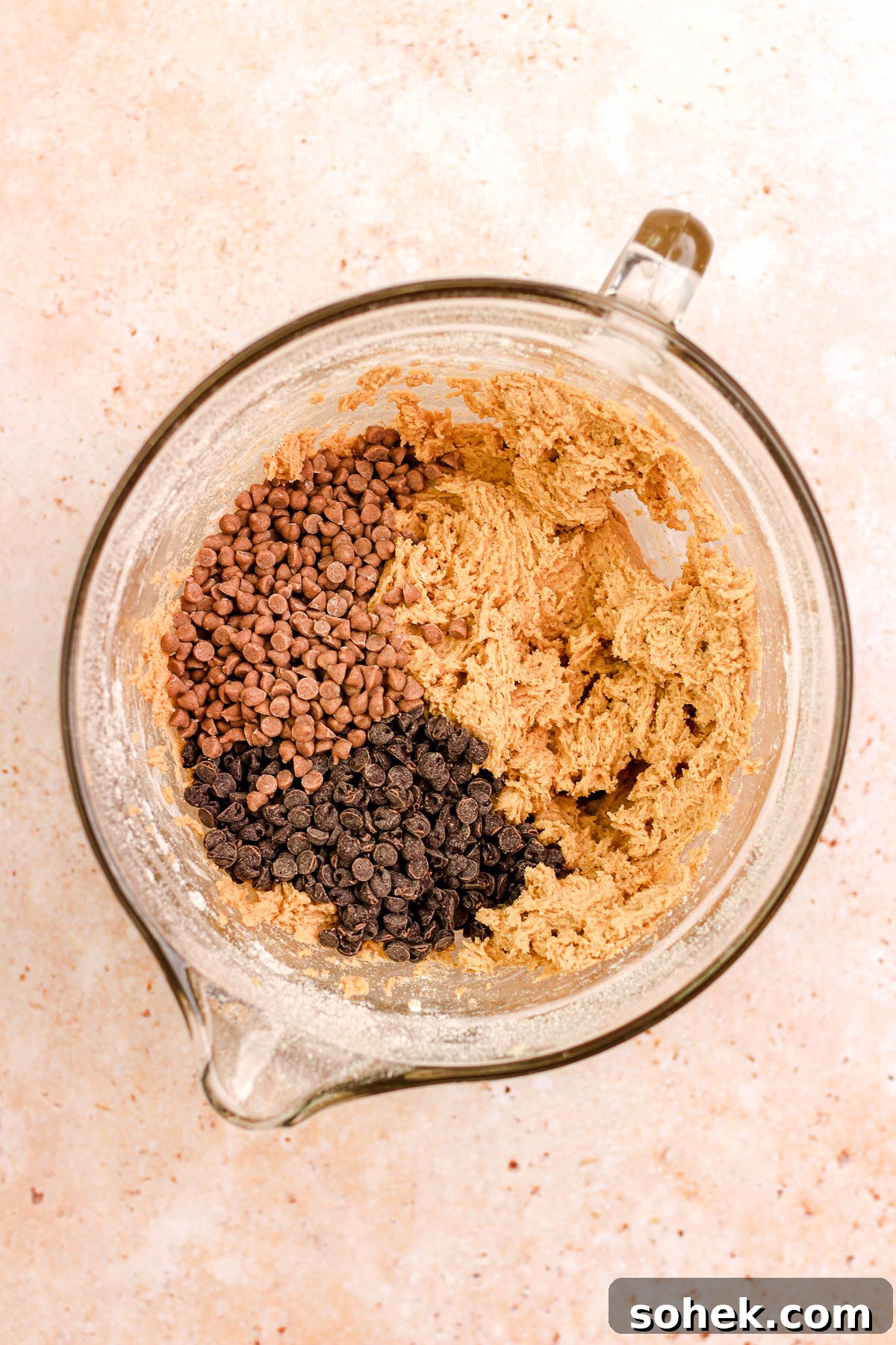 Cinnamon Chocolate Chip Cookie Recipe — Warm, Spiced Chocolate Treat 8 Cinnamon chocolate chip cookie dough with mini chocolate chips in a glass bowl.