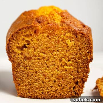 Easy Pumpkin Banana Bread Loaf With Cake Mix on White Dish.