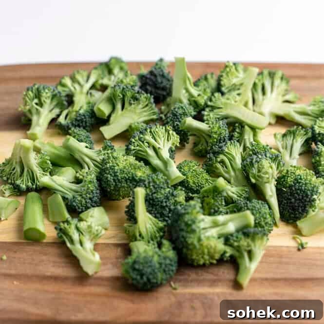 Broccoli florets on a cutting board.