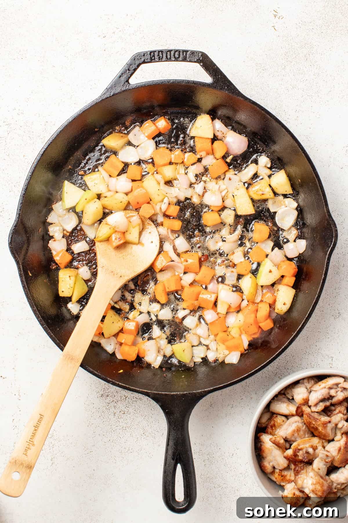 Dijon Chicken Skillet with Wild Rice and Veggies 6 Cooking carrots, apples, and shallots in a cast iron pan.