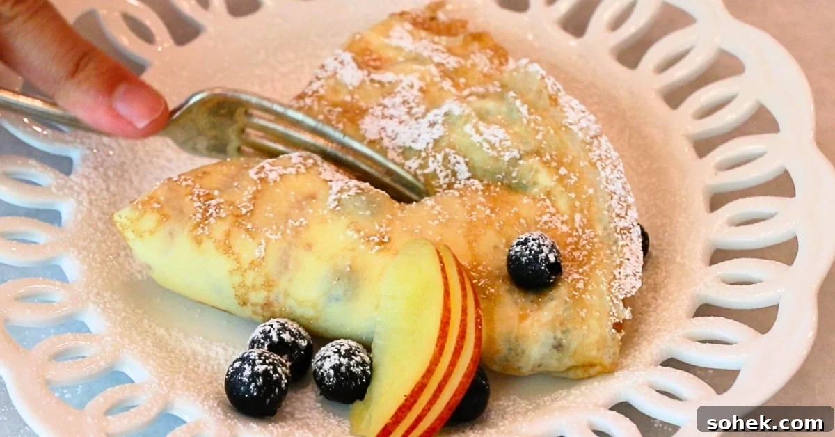 Classic French Crepes: Thin Pancake Recipe & Serving Ideas 4 a homemade crepe filled with yogurt and decorated with fruits