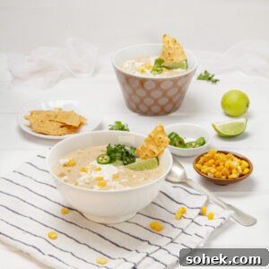 Mexican Street Corn Soup Recipe — Creamy Elote Chowder Tutorial 4 Creamy, authentic Mexican street corn soup in a bowl with chips, fresh lime wedges, and cilantro on the side.