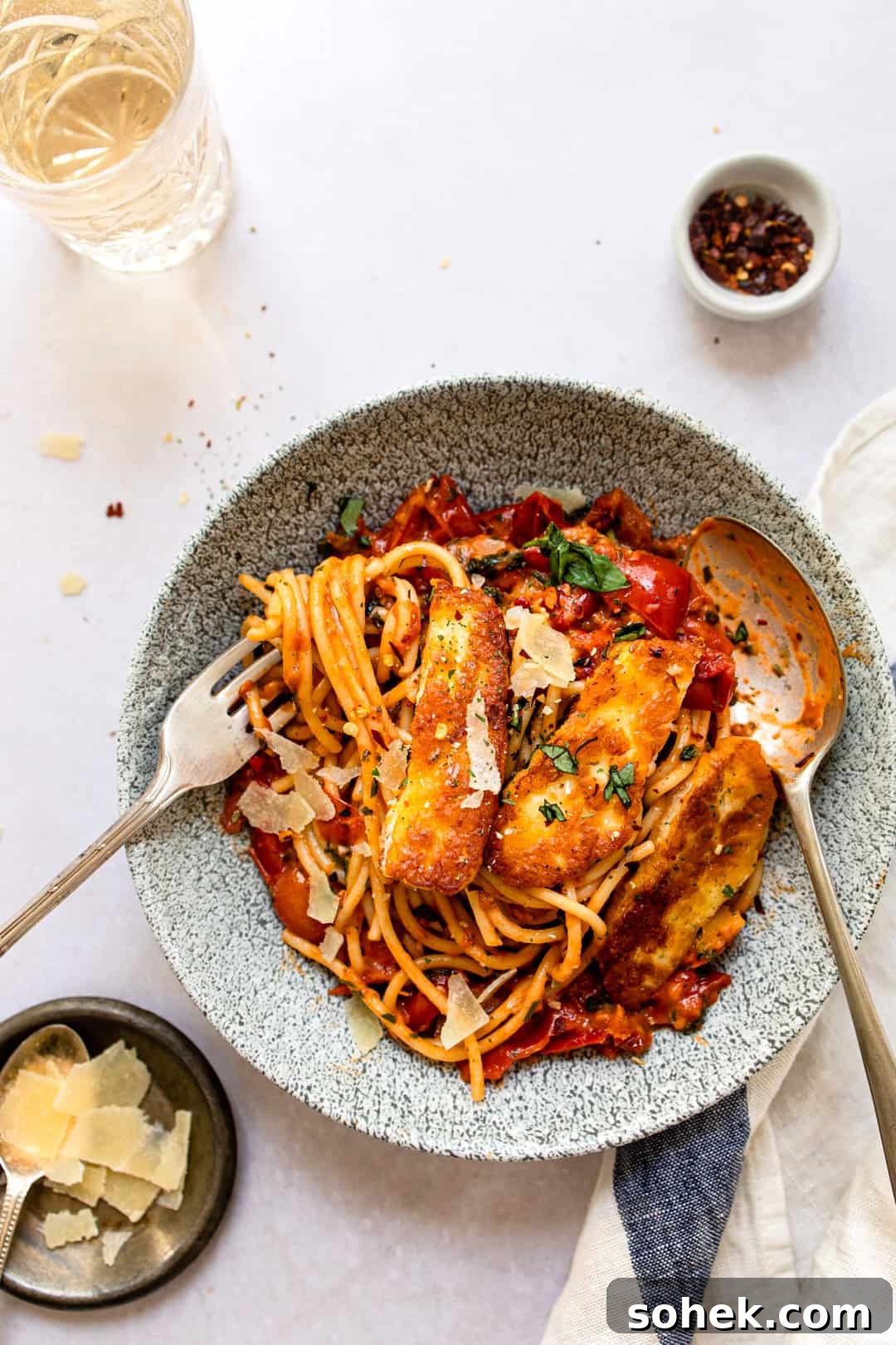 Halloumi pasta in a bowl with parmesan cheese.