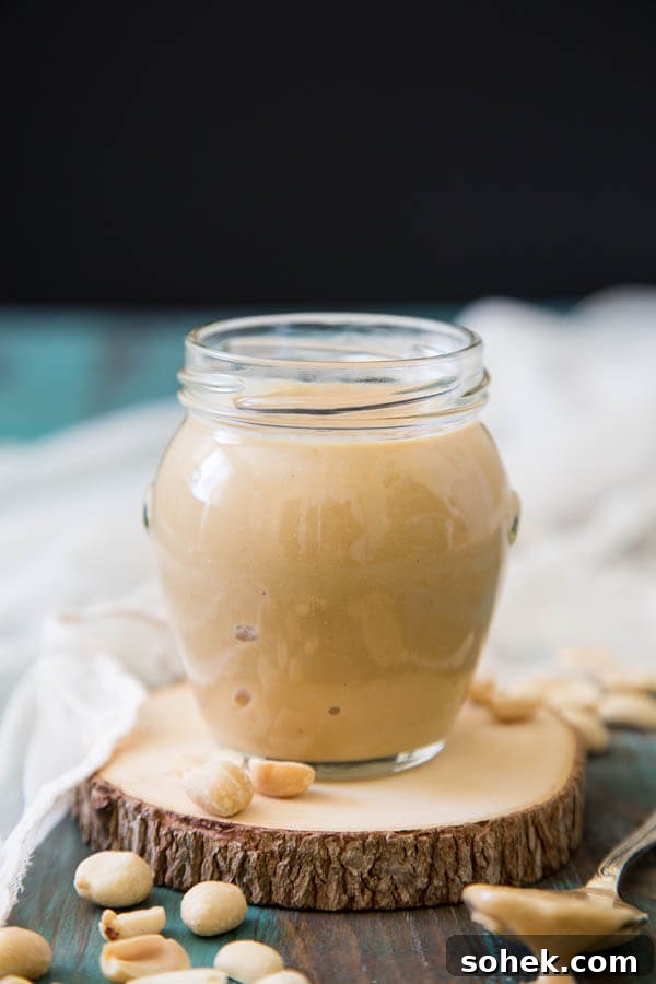 This super easy homemade peanut butter is sweetened with honey, takes just 10 minutes to make and you'll want to eat it straight from the jar, guaranteed! #wildwildwhisk #homemadepeanutbutter A jar of peanut butter