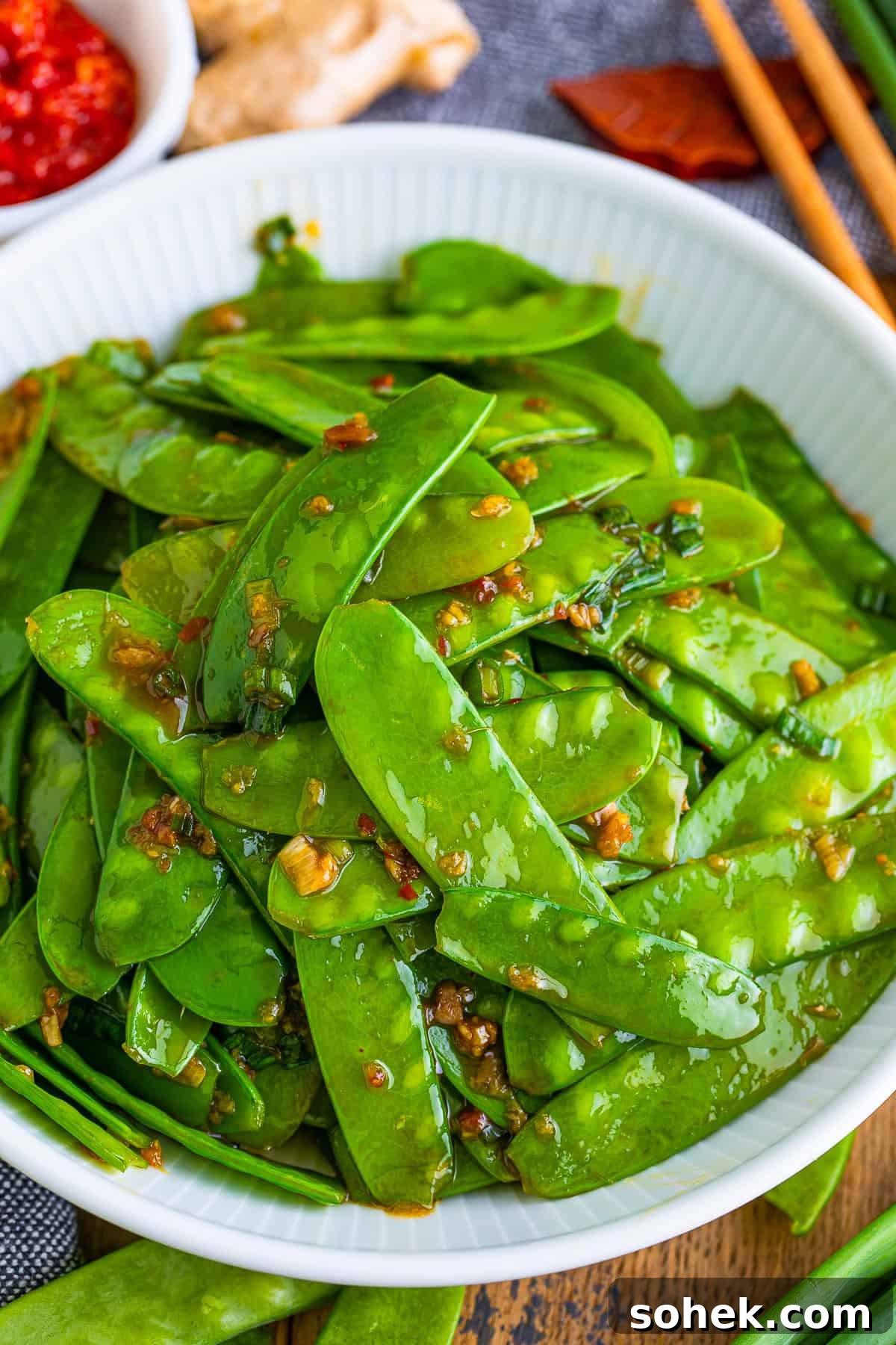 overhead image of snow peas recipe on a white bowl