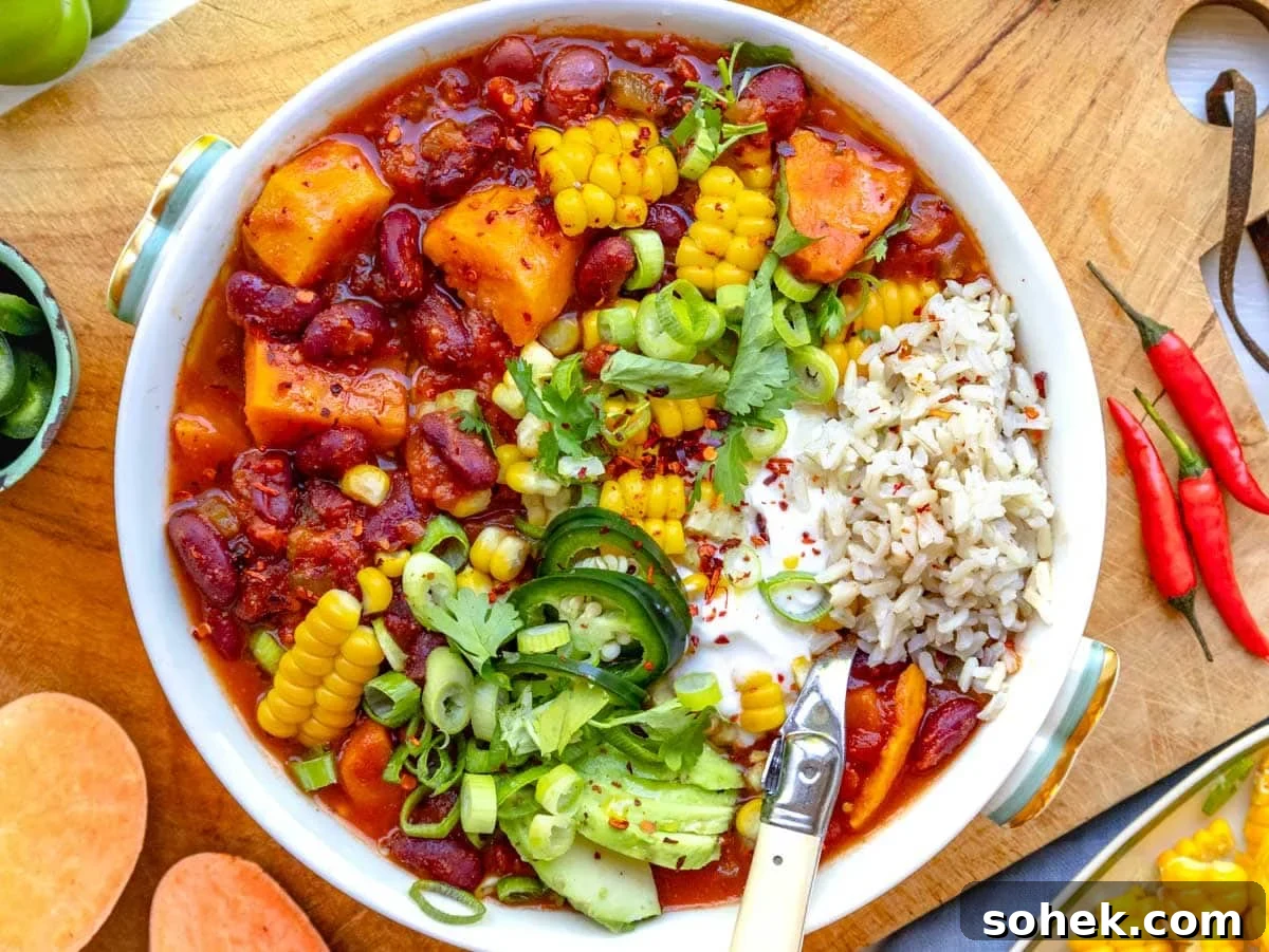 Hearty Sweet Potato Chili with Black Beans and Chipotle 3 sweet potato chili in a bowl topped with corn, lime, and cilantro