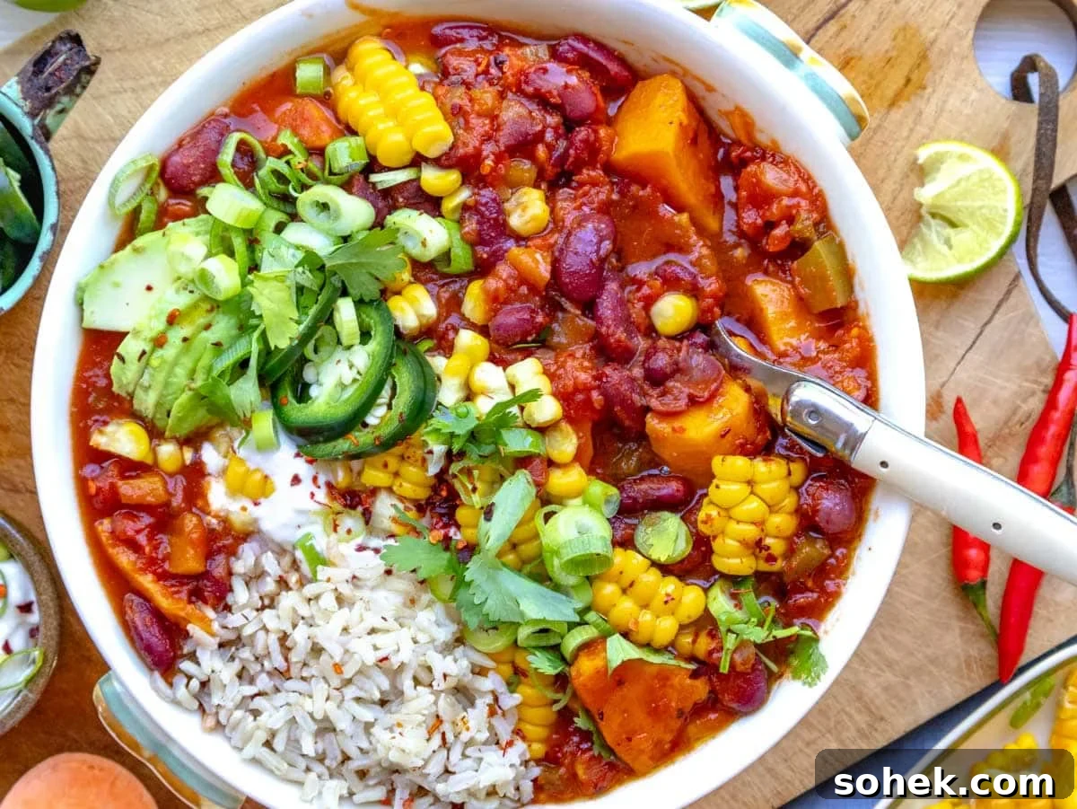 Hearty Sweet Potato Chili with Black Beans and Chipotle 5 sweet potato chili served with rice and topped with jalapeños, sour cream, and corn