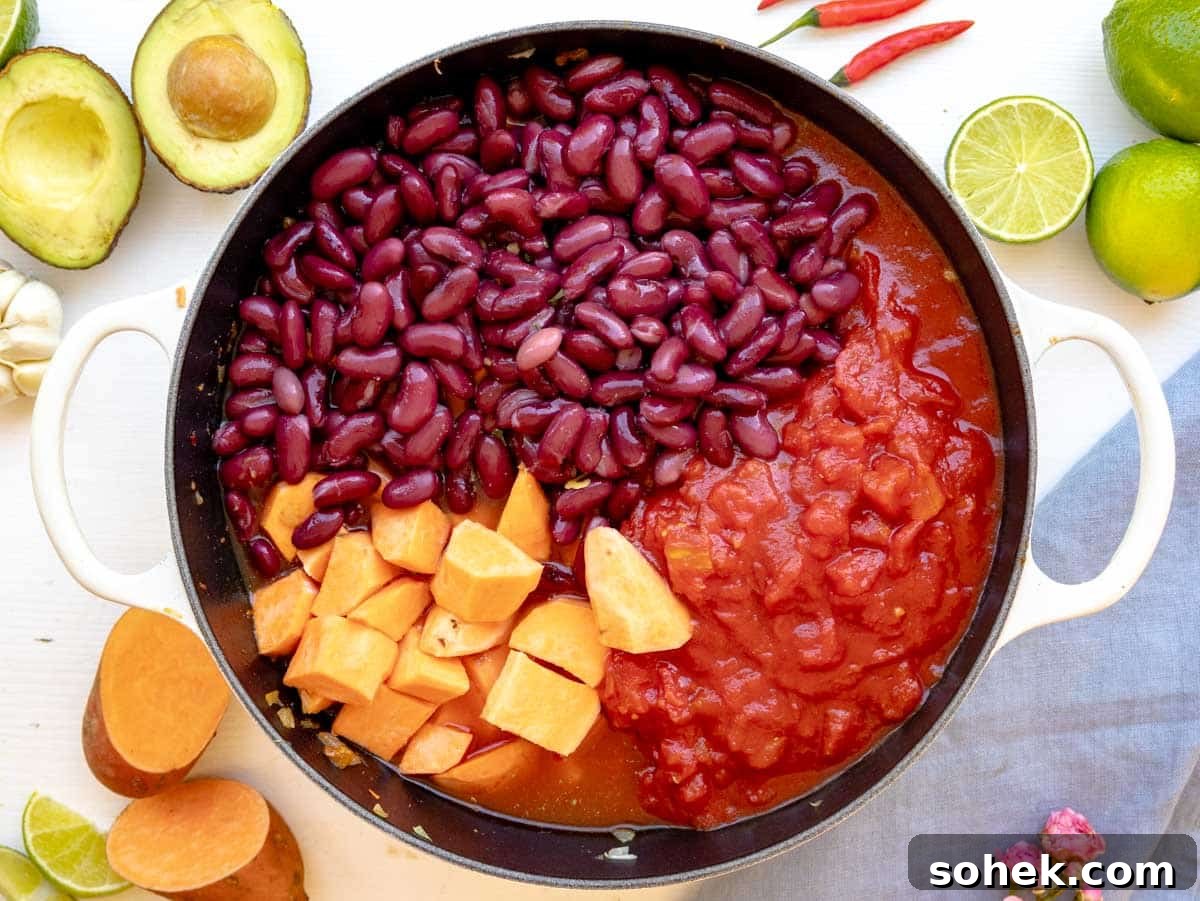 Hearty Sweet Potato Chili with Black Beans and Chipotle 7 kidney beans, sweet potatoes, and diced tomatoes added to the pot