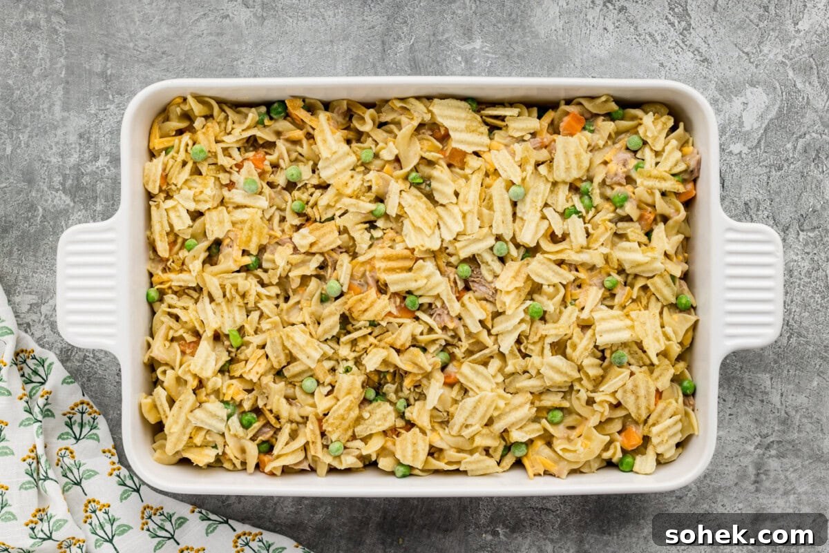 crushed potato chips on top of tuna casserole in a baking dish