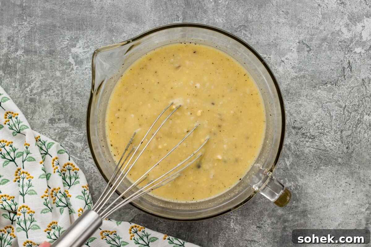tuna casserole sauce ingredients whisked in a mixing bowl