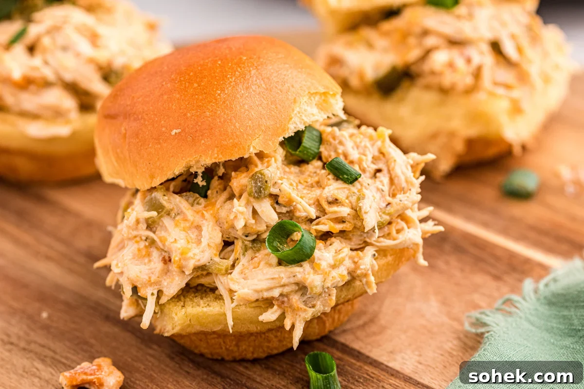 Slow Cooker Jalapeño Popper Chicken Recipe 7 a jalapeno chicken slider on a cutting board.