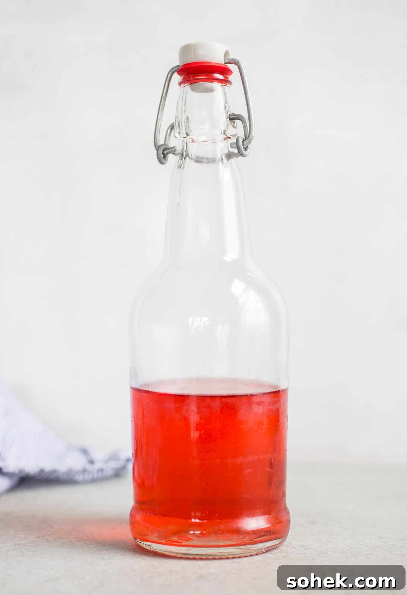 Pink liquid in a glass bottle.