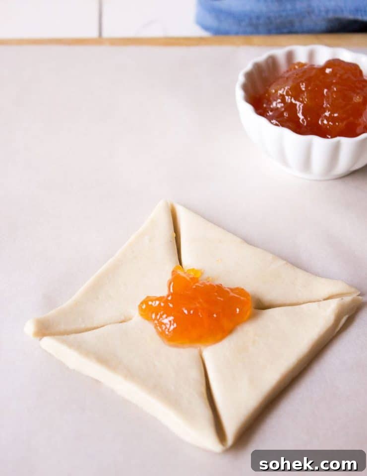Savory and Sweet Puff Pastry Pinwheels: Quick Party Appetizers 3 Making apricot jam pinwheels.