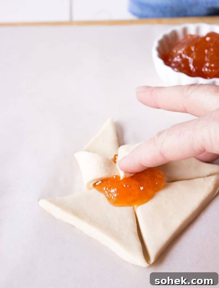 Savory and Sweet Puff Pastry Pinwheels: Quick Party Appetizers 4 Folding the corners on pinwheels.