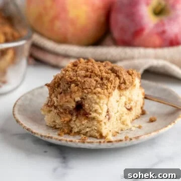 A slice of Apple Coffee Cake on a small plate.