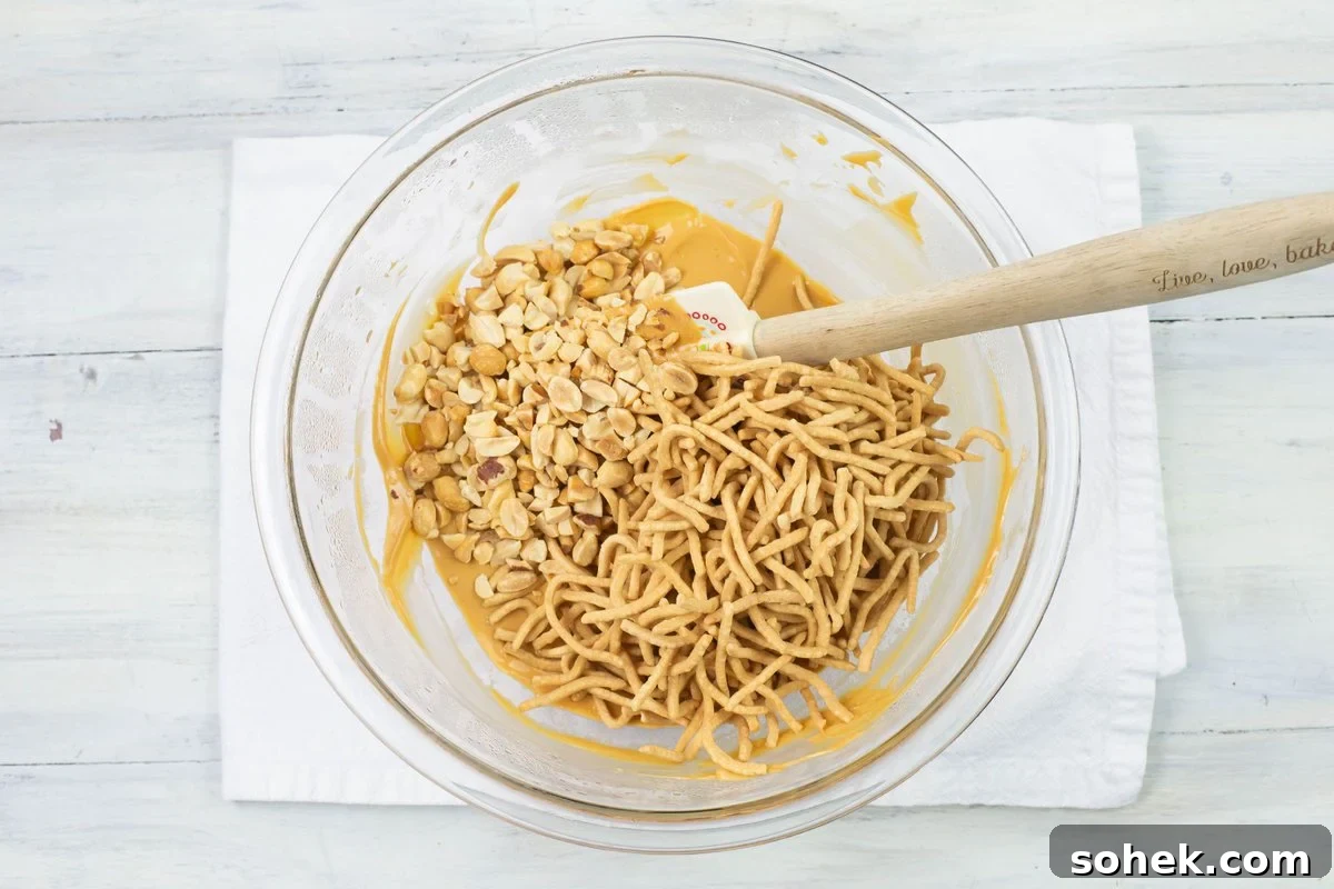 No-Bake Peanut Butter Haystack Cookies Recipe 6 Tossing and coating the crunchy noodles and crushed peanuts in a bowl.