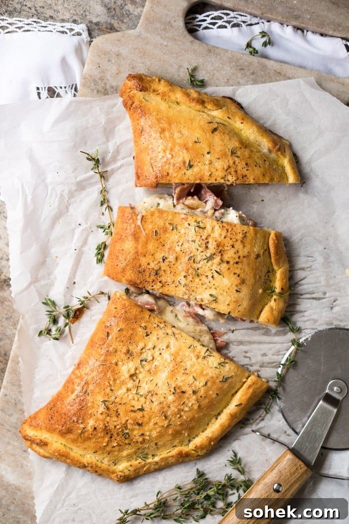 30-Minute Keto Calzones: Gluten-Free, Dairy-Free Pizza Turnovers 2 Slicing up a keto calzone with a pizza cutter