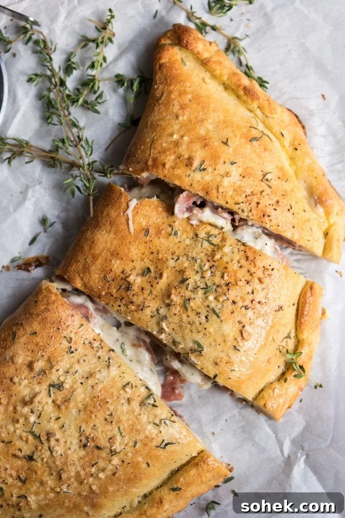 30-Minute Keto Calzones: Gluten-Free, Dairy-Free Pizza Turnovers 5 Closeup keto calzone on parchment paper with fresh thyme