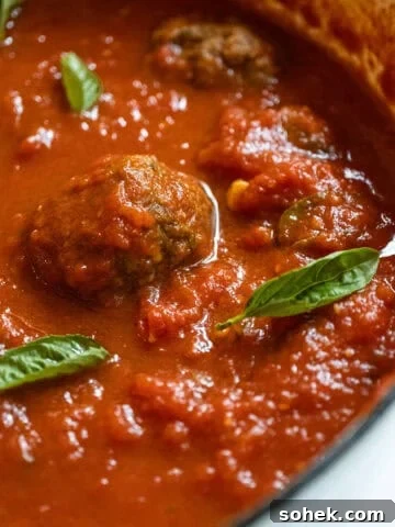 Sunday sauce with meatballs and sausage in a pot.