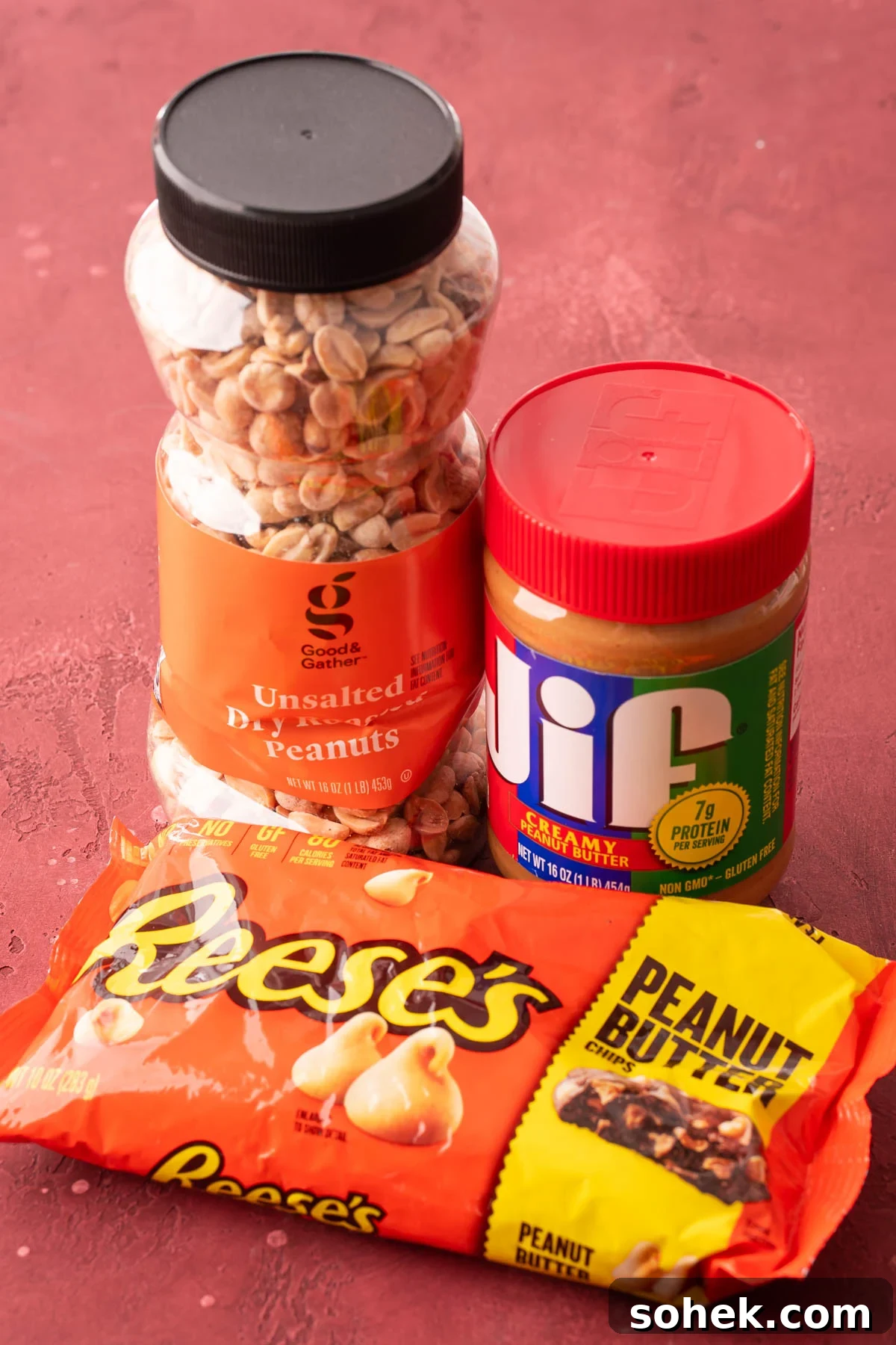 Bakery-Style Peanut Butter Cookies Recipe 4 A container of peanuts, peanut butter, and a bag of peanut butter chips on a table.