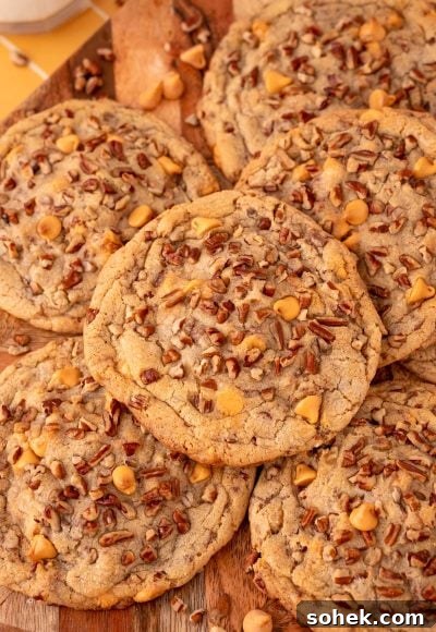 Overhead photo of butter pecan cookies on a wooden serving board.
