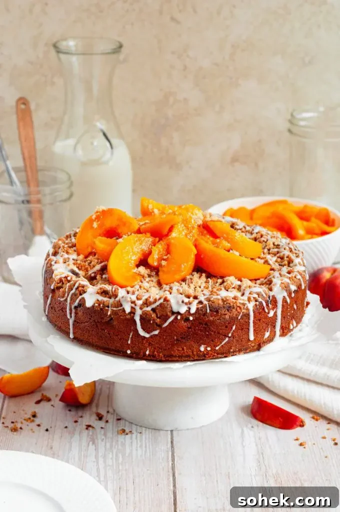 Gluten-Free Dairy-Free Peach Cupcakes: Moist Summer Dessert 10 A golden brown peach cobbler coffee cake topped with a while glaze drizzle and fresh peach slices.