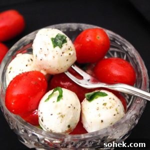Classic Caprese Salad Recipe with Fresh Mozzarella & Basil 4 Caprese salad in glass bowl garnished with basil