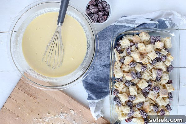 Blackberry Syrup Baked French Toast Casserole Recipe 3 Bread and blackberries in baking dish with custard filling in a bowl with a whisk