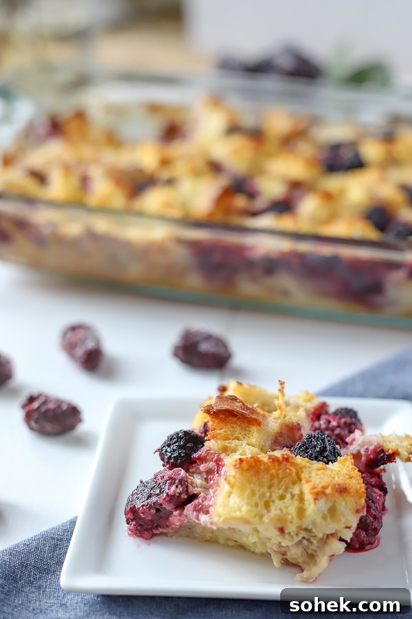 Blackberry Syrup Baked French Toast Casserole Recipe 5 Slice of French Toast Casserole with Blackberries and a baking dish in the back