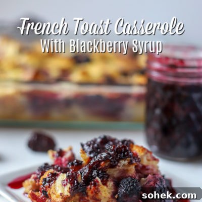 Blackberry Syrup Baked French Toast Casserole Recipe 4 Slice of French Toast Casserole with Blackberries covered with blackberry syrup and a baking dish and jar of blackberry syrup in the back